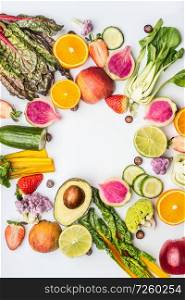 Various healthy fruits and vegetables for clean eating and diet nutrition on white. Vegetarian food background frame. Vitamin content of fruit and vegetables