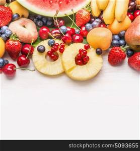 Various healthy fruits on white wooden background, top view, border, copy space