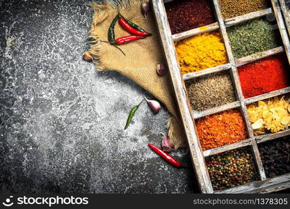 Various herbs and spices in a special box. On a rustic background.. Various herbs and spices in a special box.