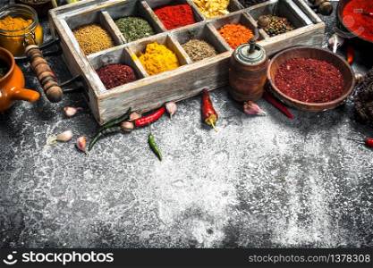 Various herbs and spices in a special box. On a rustic background.. Various herbs and spices in a special box.