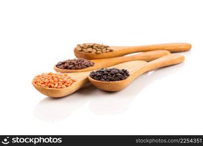Various lentils in wooden spoons isolated on white background. Collection