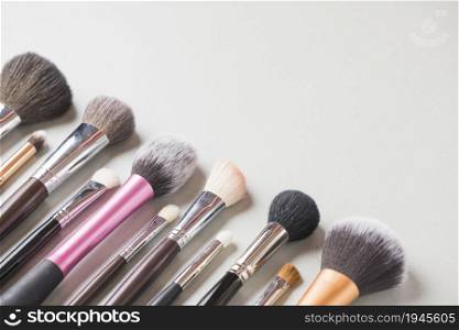 various makeup brushes arranged row white backdrop. High resolution photo. various makeup brushes arranged row white backdrop. High quality photo