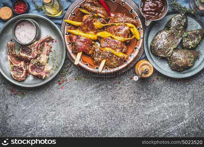 Various marinated meat in bowls for barbecue grilling or frying with spices on rustic background , kinds of meat, top view