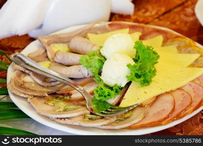 Various meat slices on white plate - collation