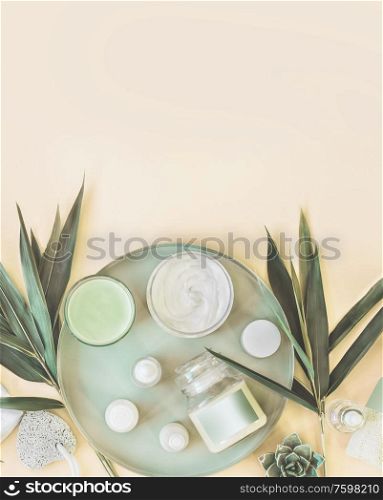 Various Moisturizing cosmetic products: cream , serum, ampule, mask on light background with palm leaves. Natural herbal facial skin care. Modern. Top view. Copy space. Branding mock-up
