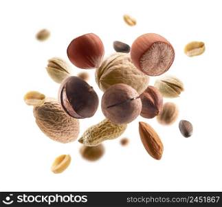 Various nuts levitate on a white background.. Various nuts levitate on a white background
