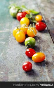 various of colorful tomatoes on wooden background. Cooking, Healthy Eating or Vegetarian concept