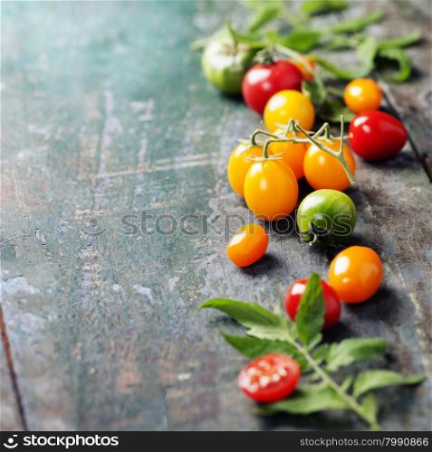 various of colorful tomatoes on wooden background. Cooking, Healthy Eating or Vegetarian concept. Background layout with free text space.
