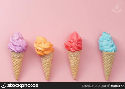 Various of colourful meringue ice cream cone on pink background for sweet and refreshing dessert concept