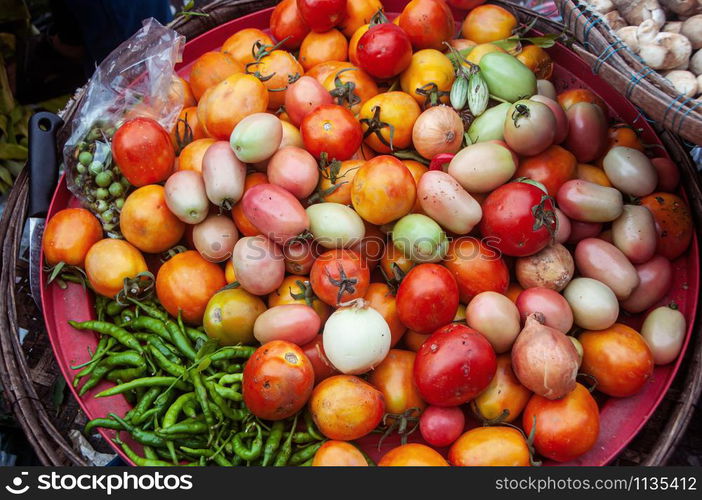 Various of fresh organic vegetables, tomatoes, chili and onion in market