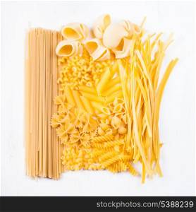 Various pasta types as a background on the table
