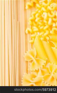 Various pasta types as a background on the table. Various pasta