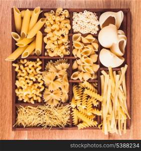 Various pasta types in the wooden box on the table