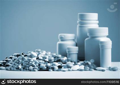 Various pills, capsules, dragee and white bottles. Toned