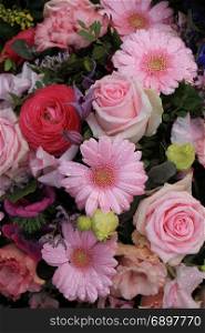 Various pink flowers in a mixed floral arrangement