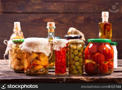 various preserved food on wooden background
