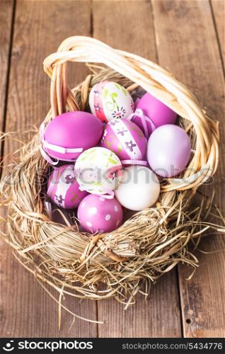 Various purple eggs in basket, Easter decorations