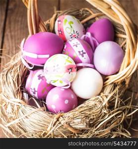 Various purple eggs in basket, Easter decorations