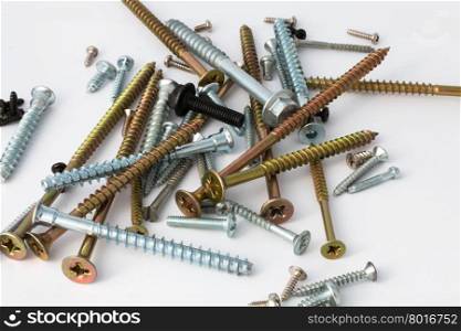 various screws and bolts close-up on a white background