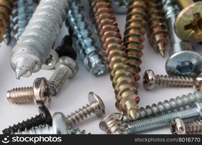 various screws and bolts close-up on a white background