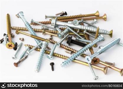 various screws and bolts close-up on a white background