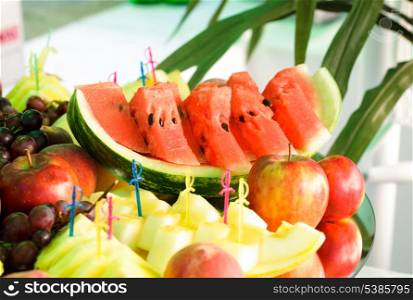 Various slices of fruits on the mirror stand prepared for eating
