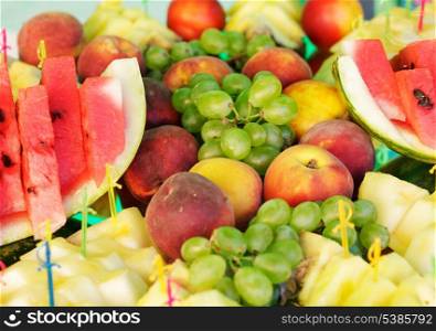 Various slices of fruits on the silver stand prepared for eating
