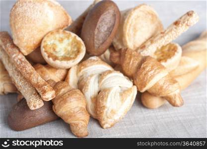 various small baked bread and buns on sacking