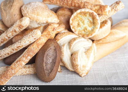 various small baked bread and buns on sacking