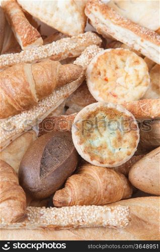various small baked bread and buns on wood