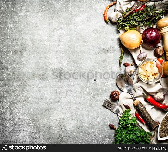 Various spices and herbs. On a stone background.. Various spices and herbs.