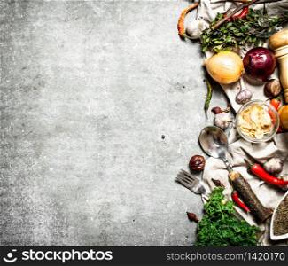 Various spices and herbs. On a stone background.. Various spices and herbs.