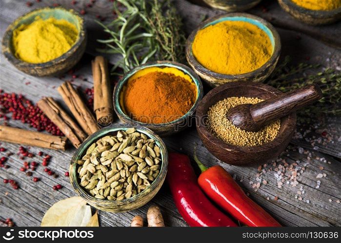 Various spices selection. Spices on wooden bowl background