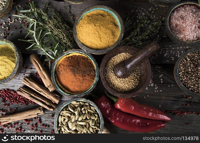 Various spices selection. Spices on wooden bowl background