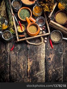 Various spicy spices and herbs. On a wooden background.. Various spicy spices and herbs.