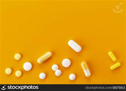 various tablets and capsules with antibiotics on a orange background. various tablets and capsules with antibiotics on a colored background