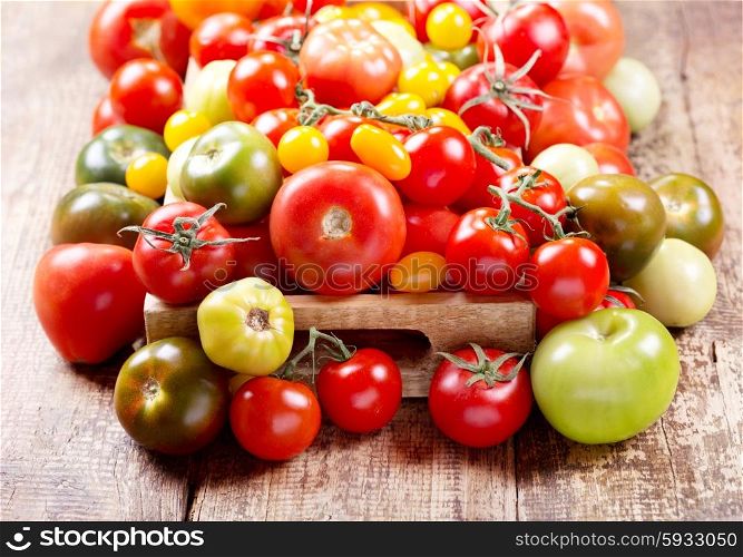 various tomatoes in wooden box