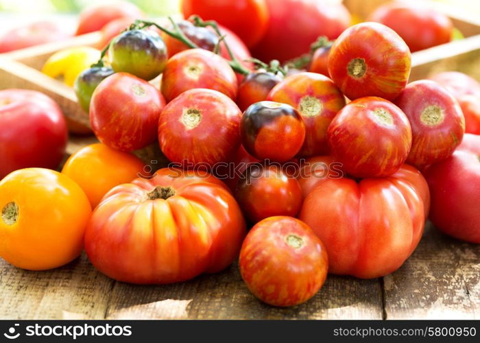 various tomatoes on wooden table