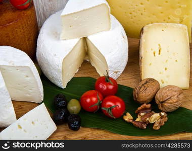 Various types of cheese on wood