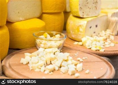 Various types of cheese on wooden desk