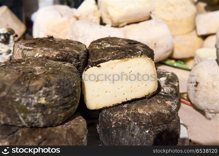 Various types of cheese on wooden desk. Various types of cheese