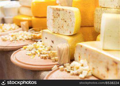 Various types of cheese on wooden desk. Various types of cheese