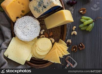 Various types of cheese set. Various types of cheese set with grapes and nuts