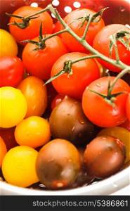 Various types of cherry tomatoes in colander