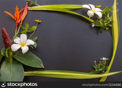 Various types of flowers arranged on a black table And have a space in the middle
