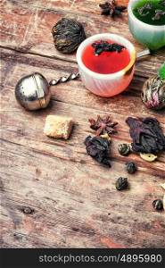 various types of fragrant herbal tea on vintage wooden background