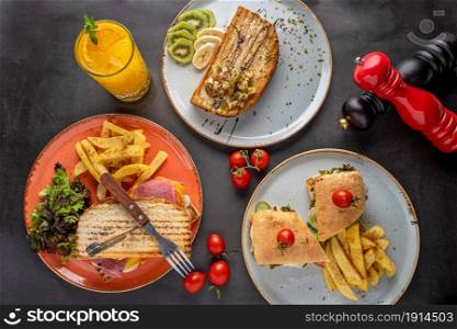 Various types of toast and sandwiches on stone table