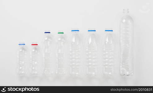 various types plastic bottles grey background