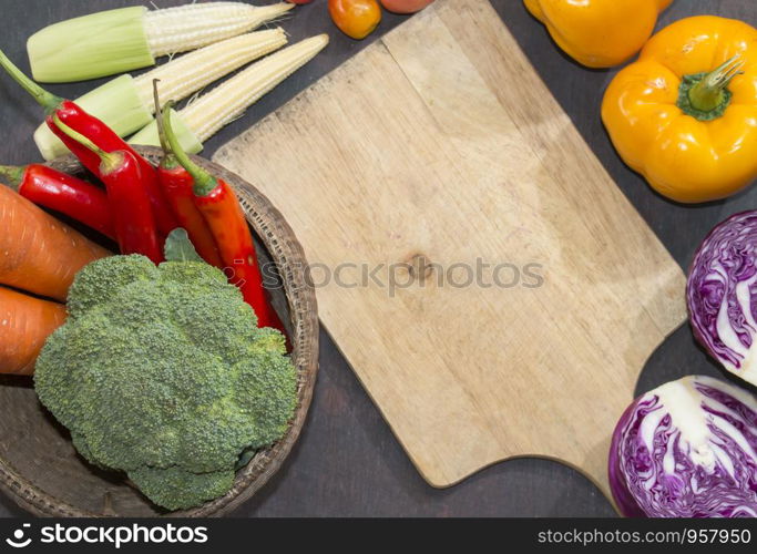 Various vegetables and spices and empty old cutting board