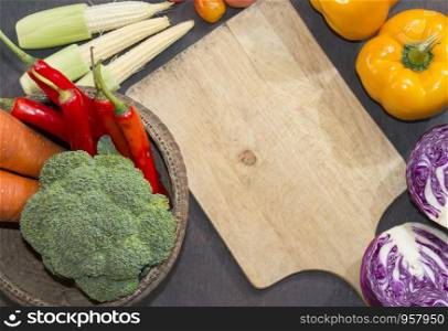 Various vegetables and spices and empty old cutting board